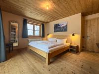 A bed or beds in a room at alpen select lodge Kleinwalsertal