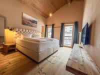 A bed or beds in a room at alpen select lodge Kleinwalsertal