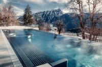 a swimming pool with a view of a mountain at Hotel Central Résidence in Leysin