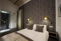A bed or beds in a room at Atypical Rooms