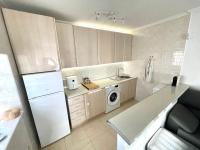 A kitchen or kitchenette at Pretty bungalow with Prívate terrace