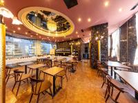 a restaurant with tables and chairs and a bar at APA Hotel Uozu Ekimae in Uozu