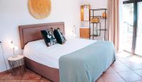 A bed or beds in a room at Caballito de Mar Boutique Hotel