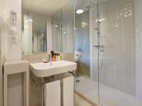 a white bathroom with a sink and a shower at Axel Hotel Barcelona - Adults Only in Barcelona