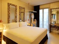 a bedroom with a large white bed and a mirror at Axel Hotel Barcelona - Adults Only in Barcelona