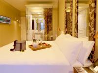a bedroom with a white bed with a tray on it at Axel Hotel Barcelona - Adults Only in Barcelona