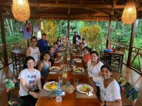 a group of people sitting at a table in a restaurant at Casa Amazonas in Puerto Maldonado