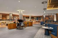 a lobby with chairs and tables in a building at Four Points by Sheraton Bintan, Lagoi Bay in Lagoi