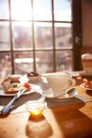 einen Tisch mit Tellern und einer Tasse Kaffee in der Unterkunft Paulinenhof in Bad Belzig