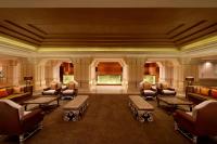 a large room with couches and tables and chairs at ITC Grand Chola, a Luxury Collection Hotel, Chennai in Chennai