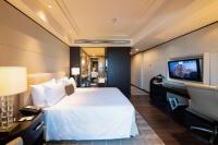a hotel room with a bed and a flat screen tv at ITC Grand Chola, a Luxury Collection Hotel, Chennai in Chennai