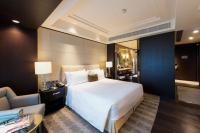 a bedroom with a large white bed and a couch at ITC Grand Chola, a Luxury Collection Hotel, Chennai in Chennai