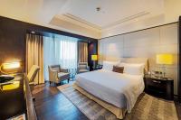 a hotel room with a large bed and a desk at ITC Grand Chola, a Luxury Collection Hotel, Chennai in Chennai