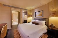 a bedroom with a large white bed and a desk at ITC Grand Chola, a Luxury Collection Hotel, Chennai in Chennai