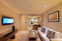a living room with a couch and a flat screen tv at ITC Grand Chola, a Luxury Collection Hotel, Chennai in Chennai