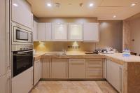 a kitchen with white cabinets and a sink at ITC Grand Chola, a Luxury Collection Hotel, Chennai in Chennai