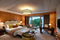a hotel room with a bed and a desk at ITC Grand Chola, a Luxury Collection Hotel, Chennai in Chennai