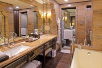 a bathroom with two sinks and a large mirror at ITC Grand Chola, a Luxury Collection Hotel, Chennai in Chennai