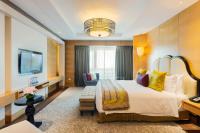 a hotel room with a large bed and a couch at ITC Grand Chola, a Luxury Collection Hotel, Chennai in Chennai