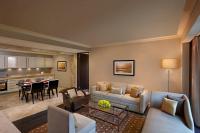 a living room with a couch and a dining room at ITC Grand Chola, a Luxury Collection Hotel, Chennai in Chennai