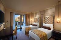 a hotel room with two beds and a television at ITC Grand Chola, a Luxury Collection Hotel, Chennai in Chennai