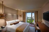 a hotel room with a bed and a desk and a window at ITC Grand Chola, a Luxury Collection Hotel, Chennai in Chennai