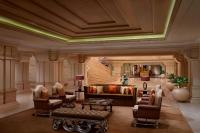 a large living room with a couch and chairs at ITC Grand Chola, a Luxury Collection Hotel, Chennai in Chennai