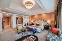 a hotel room with a bed and a couch at ITC Grand Chola, a Luxury Collection Hotel, Chennai in Chennai