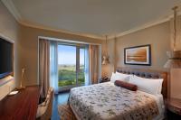 a hotel room with a bed and a large window at ITC Grand Chola, a Luxury Collection Hotel, Chennai in Chennai