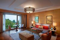 a living room with a couch and a table at ITC Grand Chola, a Luxury Collection Hotel, Chennai in Chennai