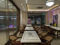 a row of tables and chairs in a restaurant at Hotel Chandraa Celebration ISBT Graphic in Dehradun