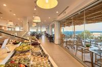 a buffet line with food on display in a restaurant at Enorme Santanna Island in Sissi