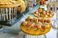 uma mesa com uma bandeja de aperitivos e bebidas em Starcity Hotel & Condotel Beachfront Nha Trang em Nha Trang