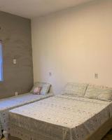 two twin beds in a room with at Pousada QUERÊNCIA FRANCÊS in Marechal Deodoro