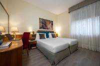 Łóżko lub łóżka w pokoju w obiekcie iH Hotels Milano Eur - Trezzano sul Naviglio