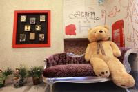 a teddy bear sitting on a chair in a room at Fasiter B&amp;B train station in Hualien City