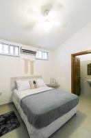 a bedroom with a large bed and a ceiling at Pineapple House in Bocas del Toro