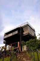 a black house with glass walls and stairs at LOFT Friburgo in Nova Friburgo
