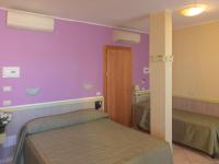A bed or beds in a room at Hotel Arco Romana