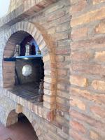an oven in a brick wall with jars on a shelf at Vecchio Frantoio Villa Rosa - Pet Friendly in Martinsicuro