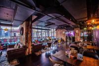 a room with a bar with couches and tables at Canal Central Hotel Business Bay in Dubai