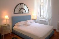 a bedroom with a large bed with white sheets and pillows at Villa Spalletti Trivelli - Small Luxury Hotels of the World in Rome