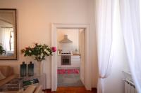 a living room with a vase of flowers and a kitchen at Villa Spalletti Trivelli - Small Luxury Hotels of the World in Rome