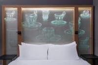 a bedroom with a display of glass vases at Le Méridien Vienna in Vienna