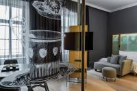 a living room with a glass table with a vase at Le Méridien Vienna in Vienna