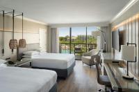 a hotel room with two beds and a desk at Orlando World Center Marriott in Orlando