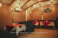 a restaurant with two tables with red and white tablecloths at Chintan Chautari in Itahari