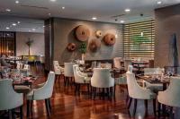 een eetkamer met tafels en witte stoelen bij The Ritz-Carlton, Santiago in Santiago