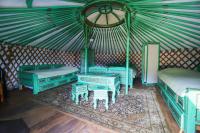 a room with blue beds and tables in a yurt at Yourtes Olachat proche Annecy in Faverges
