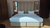 سمت ان النرجس للشقق المخدومة - Samt Inn Al Narjis Serviced Apartmentsにあるベッド